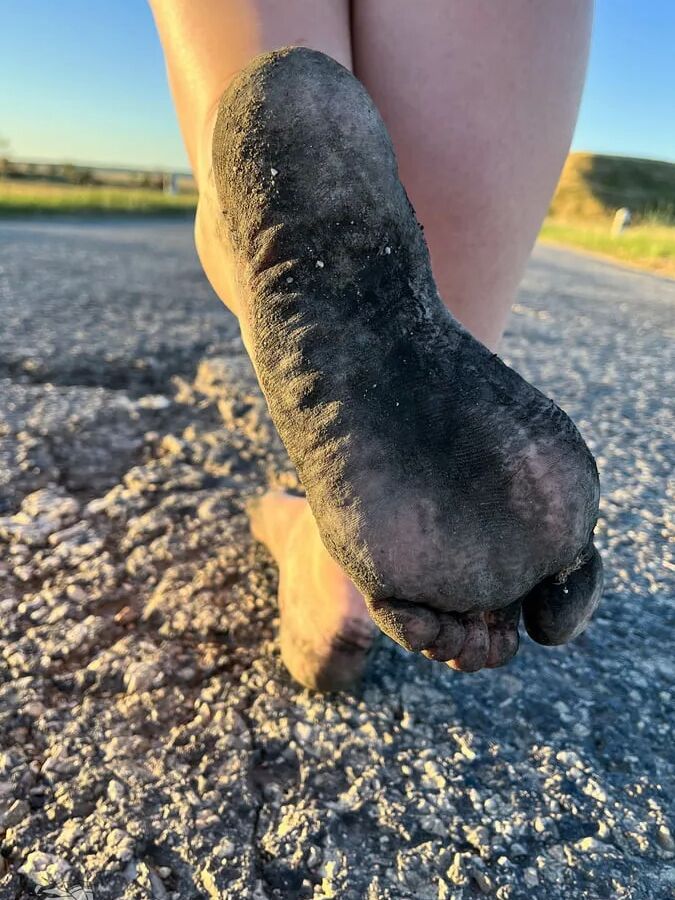 Torn and dirty feet in pantyhose outdoor