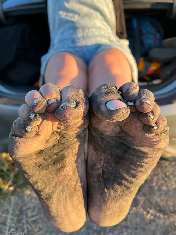Torn and dirty feet in pantyhose outdoor