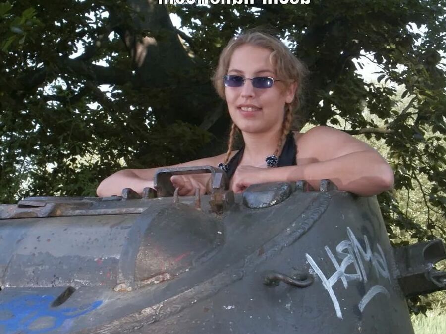 Teen Nathalie poses on an old Hotchkiss APC
