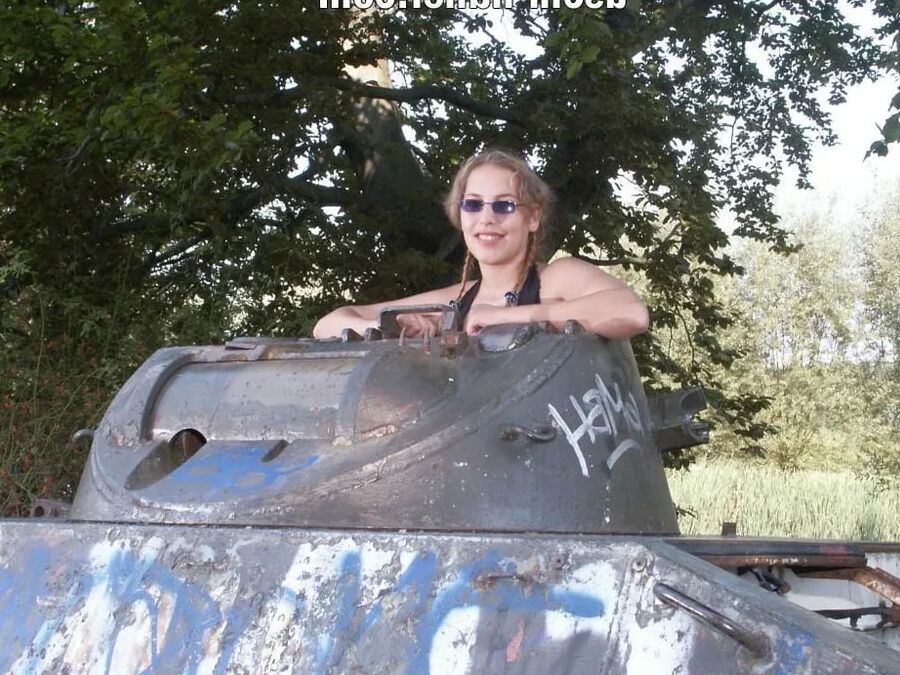 Teen Nathalie poses on an old Hotchkiss APC