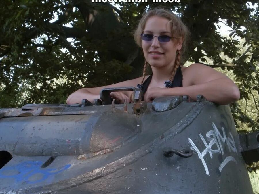 Teen Nathalie poses on an old Hotchkiss APC
