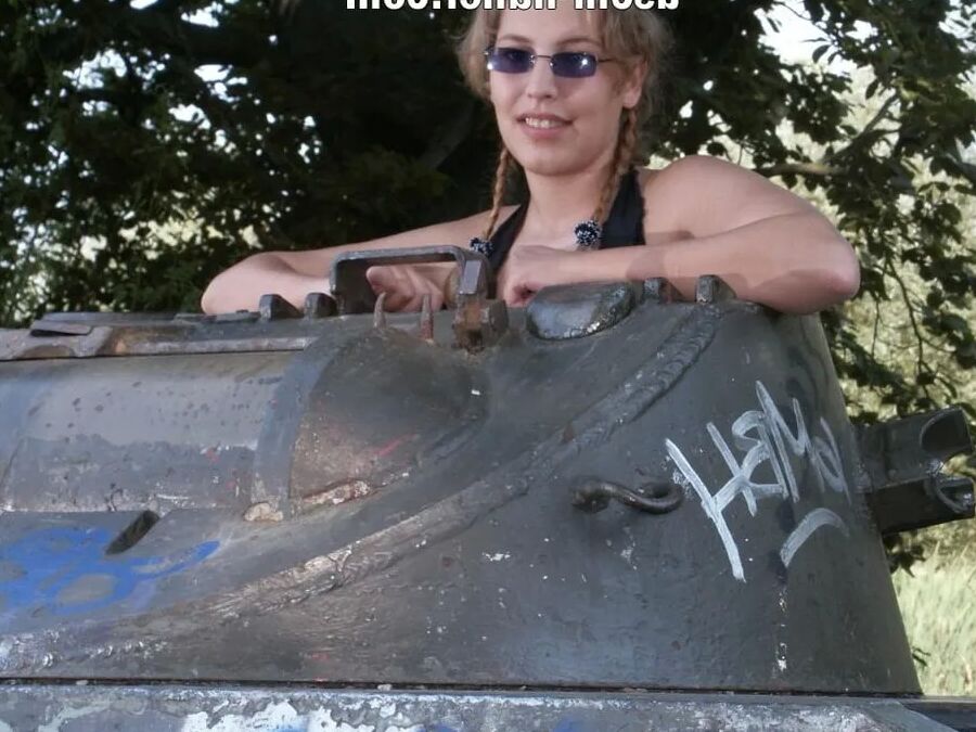 Teen Nathalie poses on an old Hotchkiss APC
