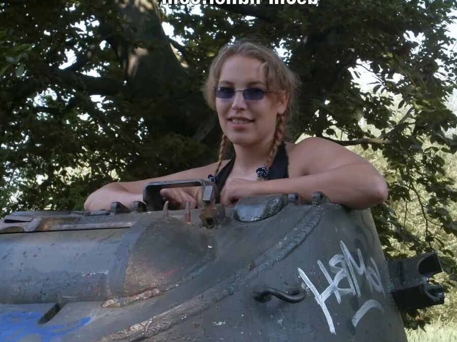 Teen Nathalie poses on an old Hotchkiss APC