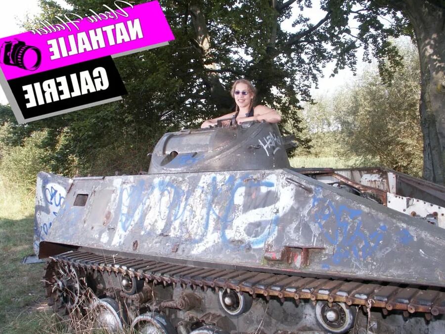 Teen Nathalie poses on an old Hotchkiss APC