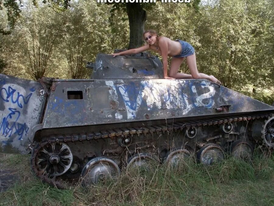 Teen Nathalie poses on an old Hotchkiss APC