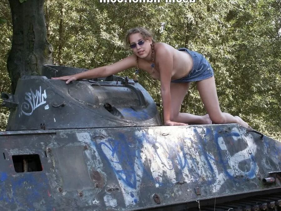 Teen Nathalie poses on an old Hotchkiss APC