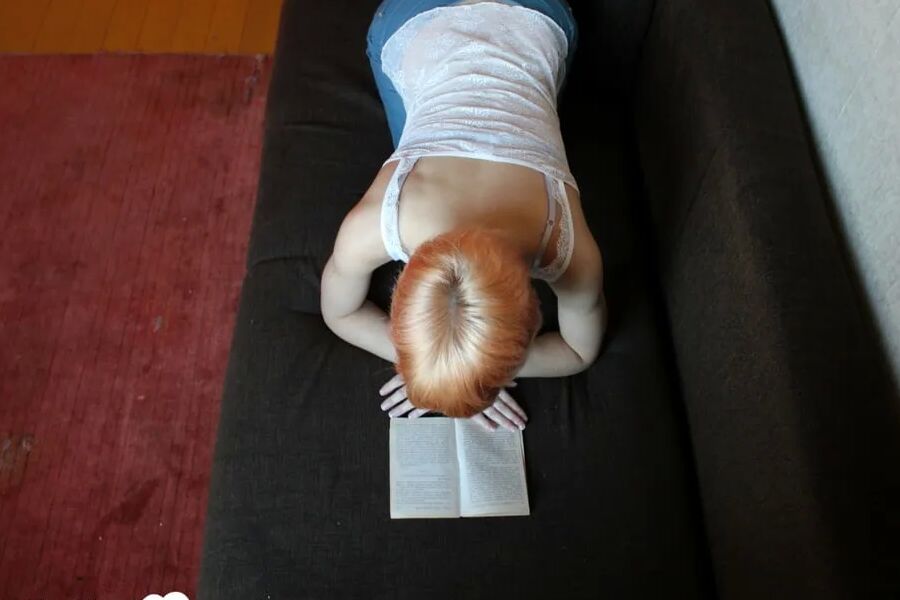 Smoking redhead takes a break from studying