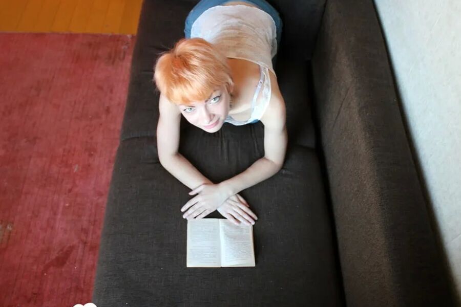 Smoking redhead takes a break from studying