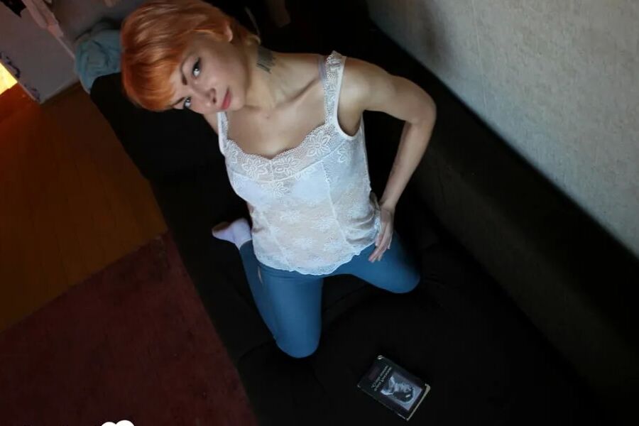 Smoking redhead takes a break from studying