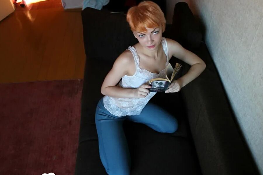 Smoking redhead takes a break from studying