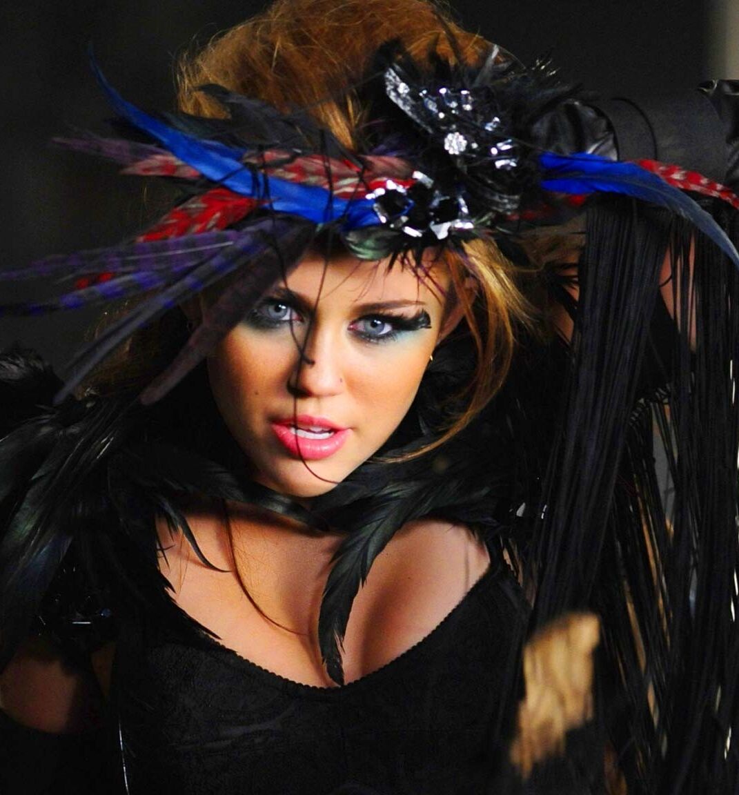 Miley Cyrus showing huge cleavage and great legs in some photoshoot
