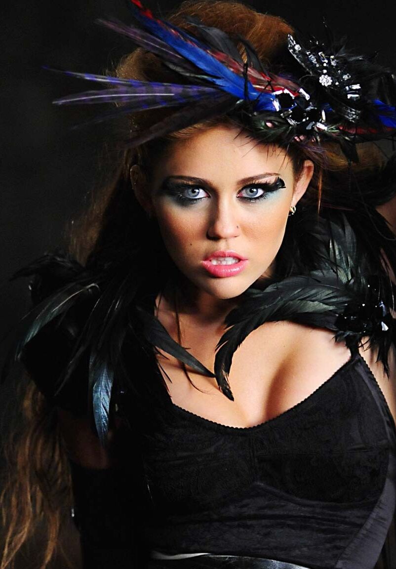 Miley Cyrus showing huge cleavage and great legs in some photoshoot