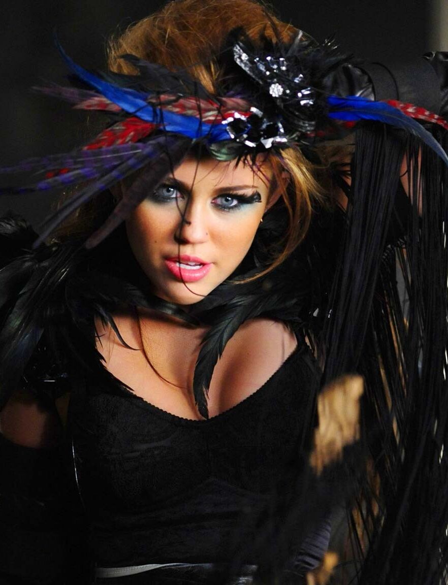 Miley Cyrus showing huge cleavage and great legs in some photoshoot