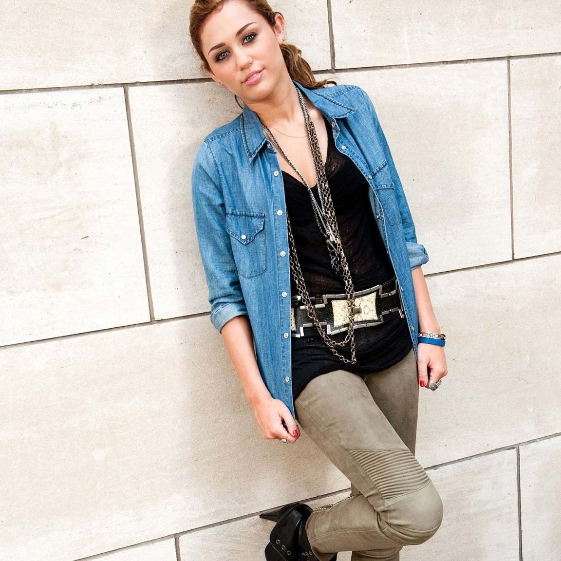 Miley Cyrus showing huge cleavage and great legs in some photoshoot