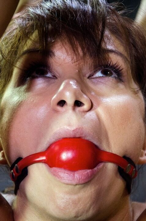 Lea Lexis is bound and ballgagged in dungeon her ass spanked red