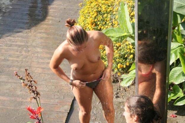 Blonde milf nudist strips down naked at a public beach