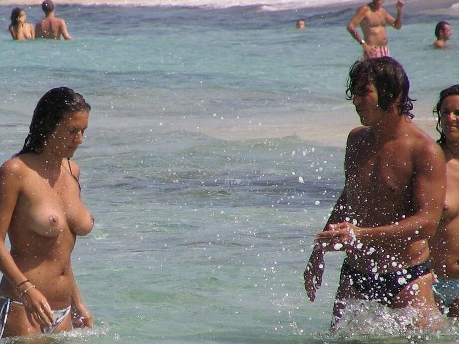 Blonde milf nudist strips down naked at a public beach