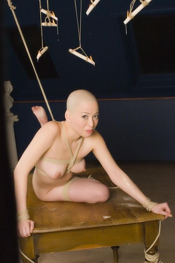 Bald chick gets covered with candle wax
