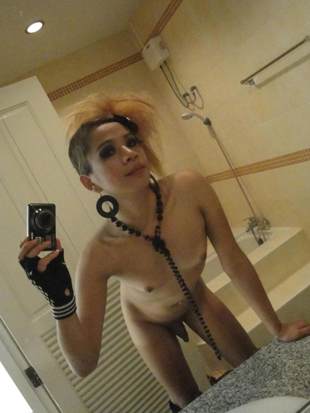 Cute femboy strips and takes pics of herself in the bathroom
