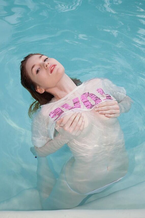 Redhead teen Holly Steele gets all wet for you in the pool