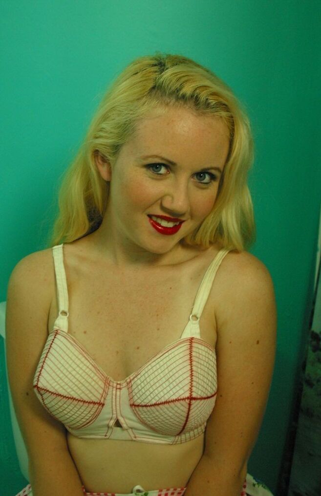 Blonde Emily shows off in stockings and sheer panties