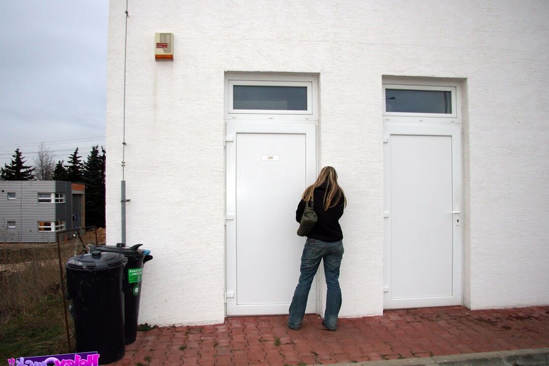 Teenage girl pleasing an anonymous cock in a public toilet