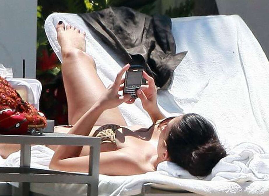 Kim Kardashian exposing her sexy body and huge boobs in bikini on pool
