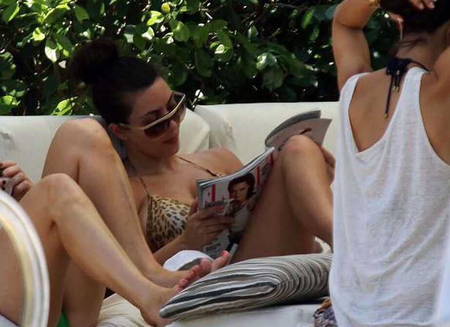 Kim Kardashian exposing her sexy body and huge boobs in bikini on pool