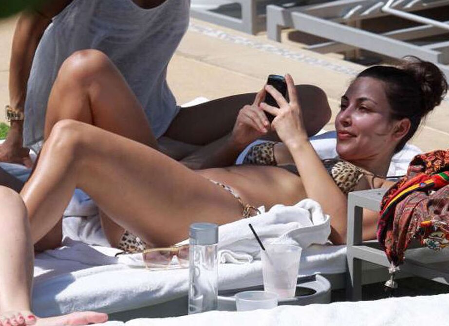 Kim Kardashian exposing her sexy body and huge boobs in bikini on pool