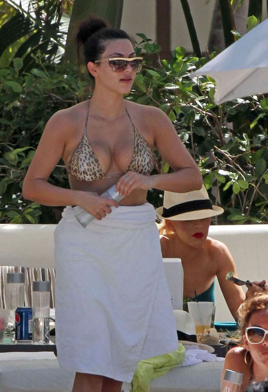 Kim Kardashian exposing her sexy body and huge boobs in bikini on pool