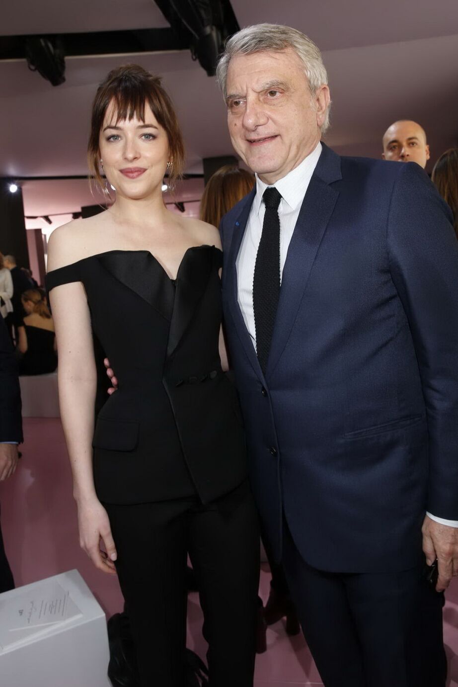 Dakota Johnson showing big cleavage in black jumpsuit at Christian Dior Fashion