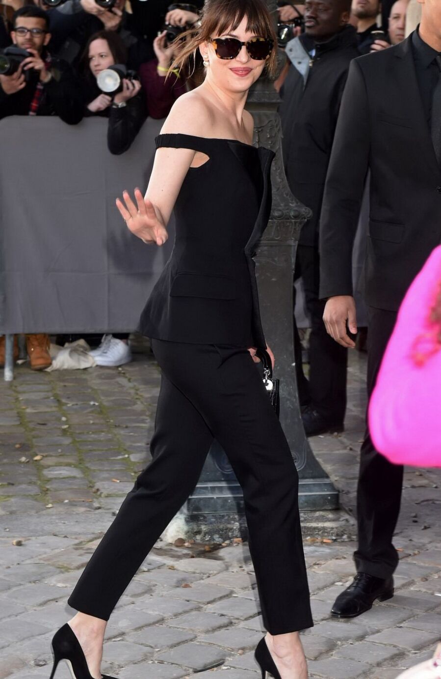 Dakota Johnson showing big cleavage in black jumpsuit at Christian Dior Fashion