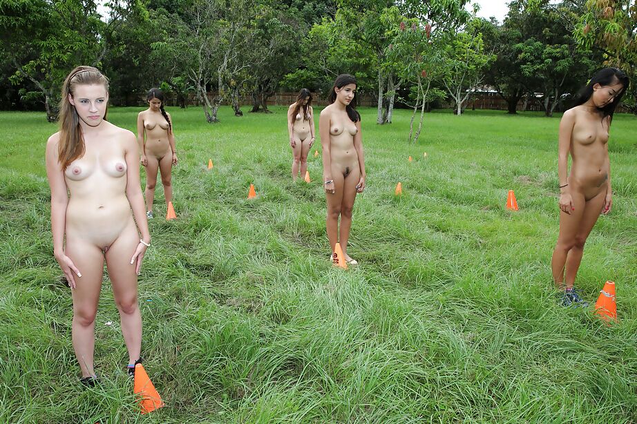 Pretty naked lesbians are standing naked and showing their bodies outdoor