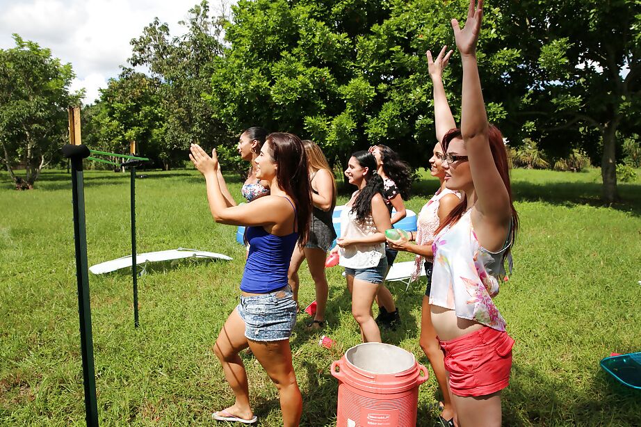 Pretty naked lesbians are standing naked and showing their bodies outdoor