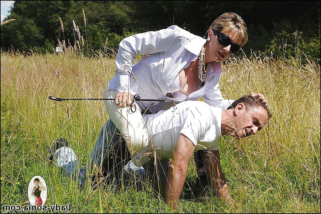 15P Fully clothed mature femdom in sunglasses abuses her male pet outdoor