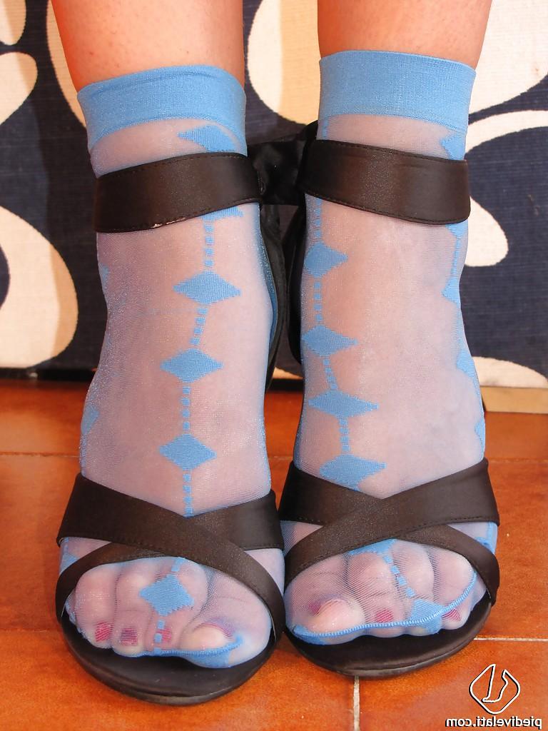 16P Blonde beauty in blue stockings is showing her adorable feet and legs