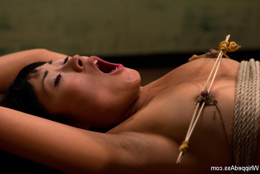 15P Adroable Asian sub slut is spanked, tit tortured, tied spread eagle and strap-on