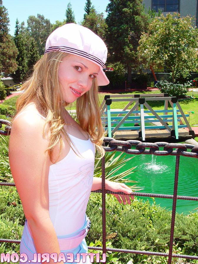 16P An adorable blonde teenager outdoors shows pussy
