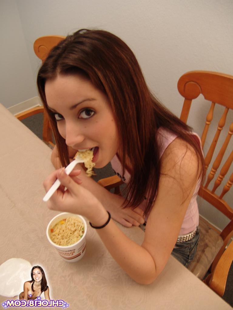 16P An adorable brunette teen chick is having a snack
