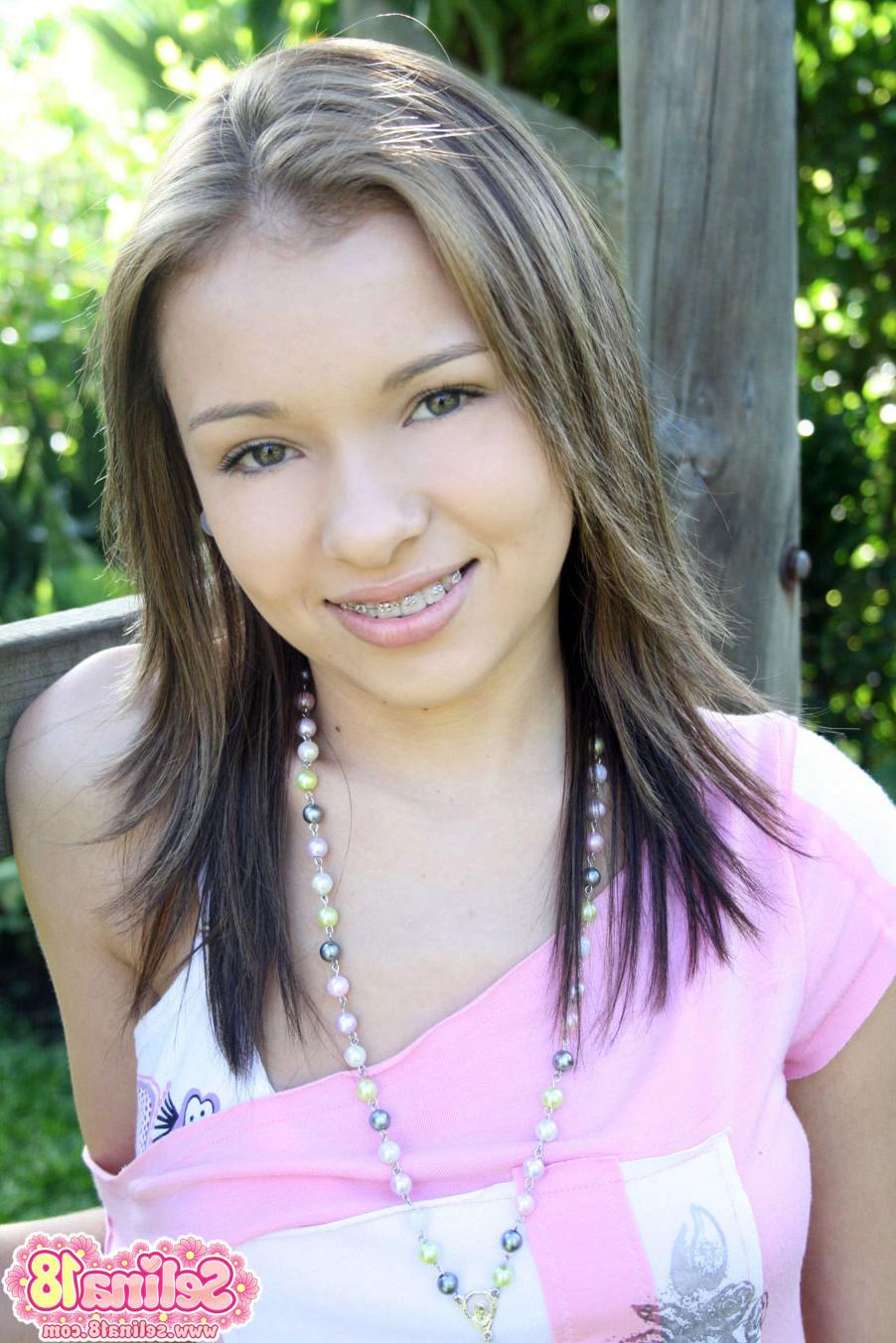 16P Adorable teenager with braces outdoors on a swing
