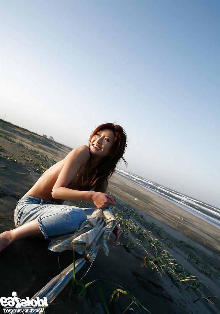14P Lovely asian babe Yu Satome uncovering her big tits outdoor