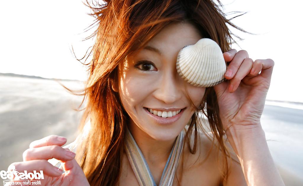 14P Lovely asian babe Yu Satome uncovering her big tits outdoor