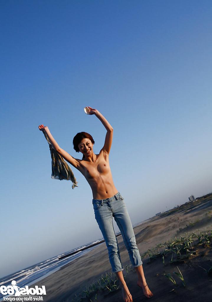 14P Lovely asian babe Yu Satome uncovering her big tits outdoor