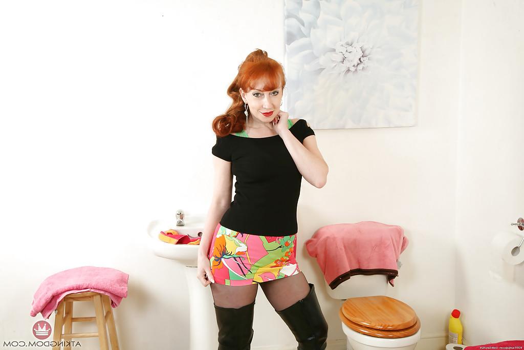15P Aged redhead woman by name of Red posing for naughty hose and boot pics
