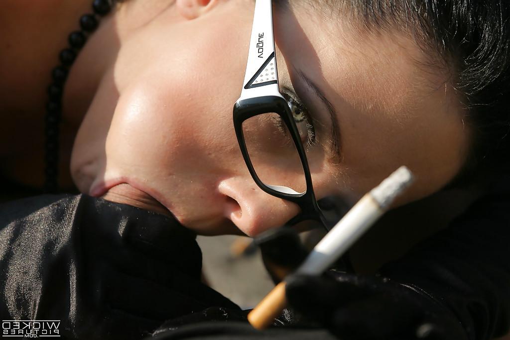 16P Pornstar Aliz enjoying a smoke while tugging on a cock outdoors