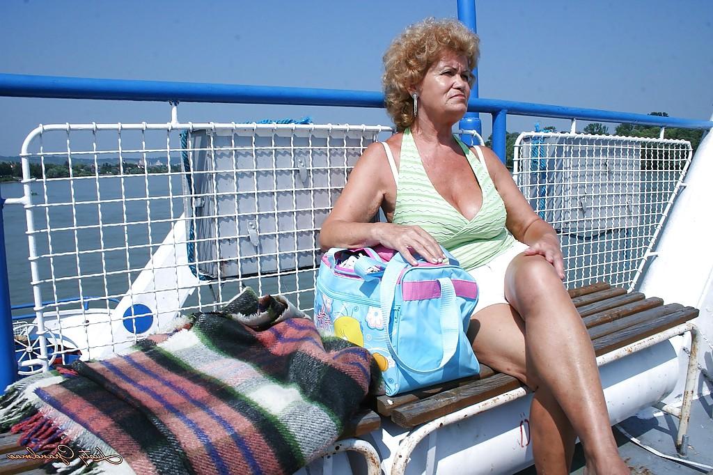 16P Fatty granny with big boobs stripping off her clothes outdoor