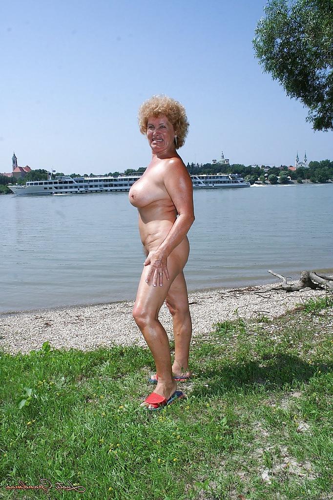 16P Fatty granny with big boobs stripping off her clothes outdoor