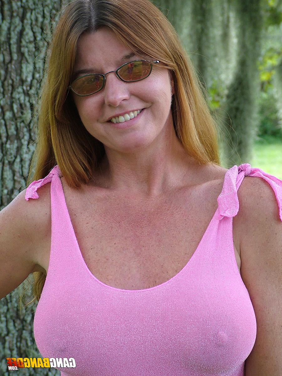 15P Mature amateur redhead Dee Delmar flashes big tits & naked upskirt outdoors