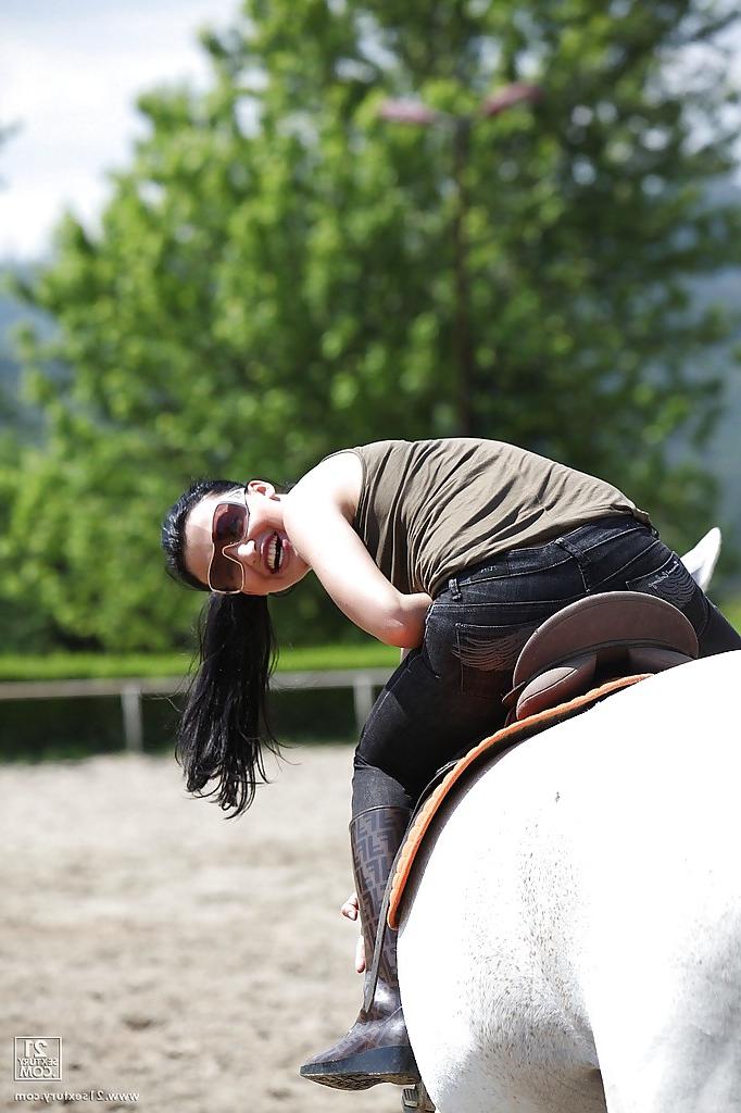16P Pornstar Aletta Ocean is riding a horse outdoor in glasses