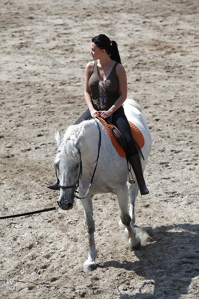16P Pornstar Aletta Ocean is riding a horse outdoor in glasses